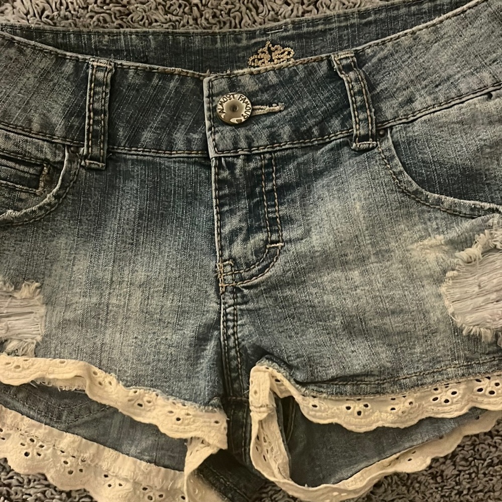 Light blue Jean shorts with beautiful white ruffle on the bottom.